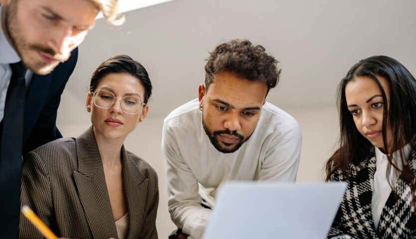 Four people collaborating on year-end tax planning strategies